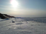 Winter beach toward lighthouse